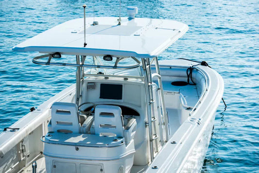 White center console fishing boat with T-top roof floating on calm blue water