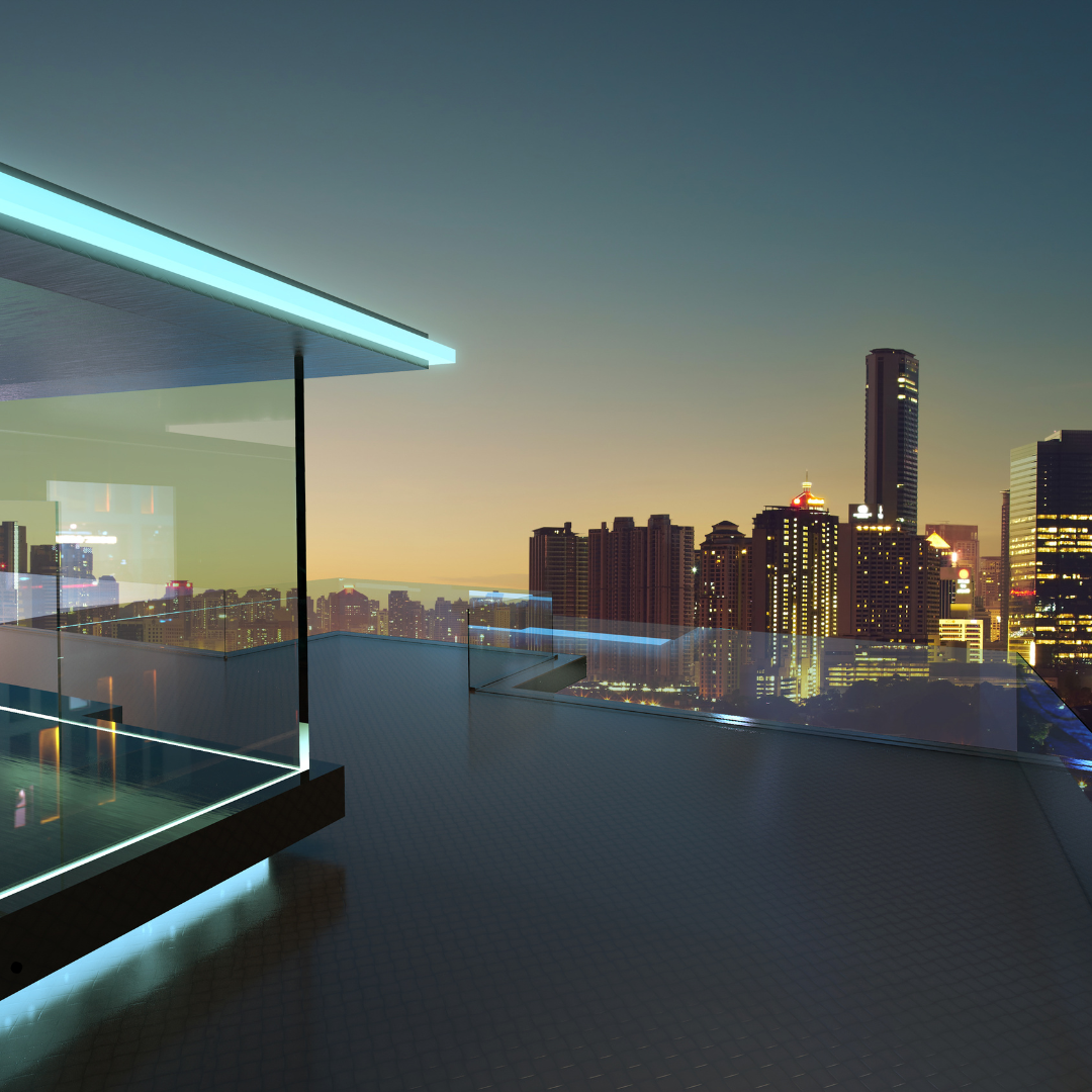 Modern rooftop terrace with glass railing overlooking illuminated city skyline at dusk