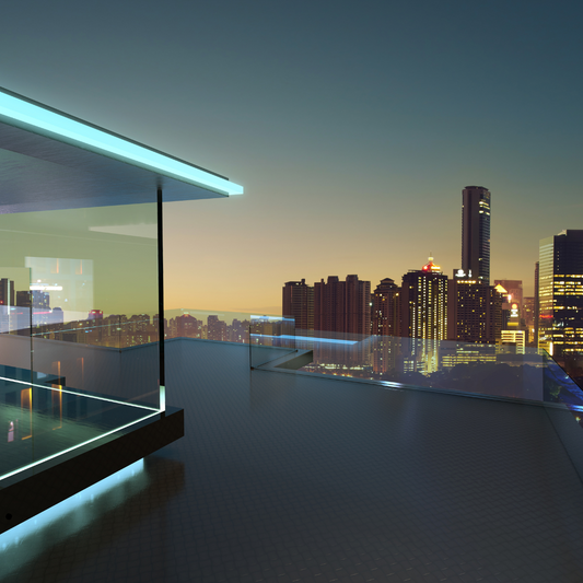 Modern rooftop terrace with glass railing overlooking illuminated city skyline at dusk