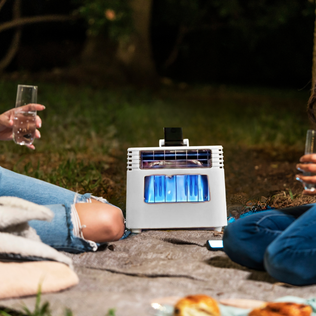 BlazOn EMBER portable propane patio heater warming an outdoor gathering at dusk, fan spinning, no extension cord